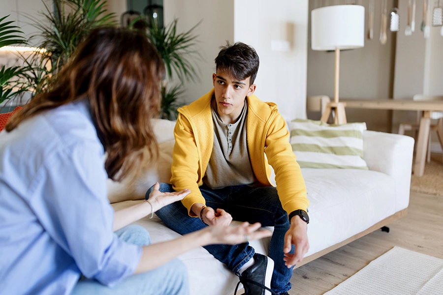 Mother and son talking at home