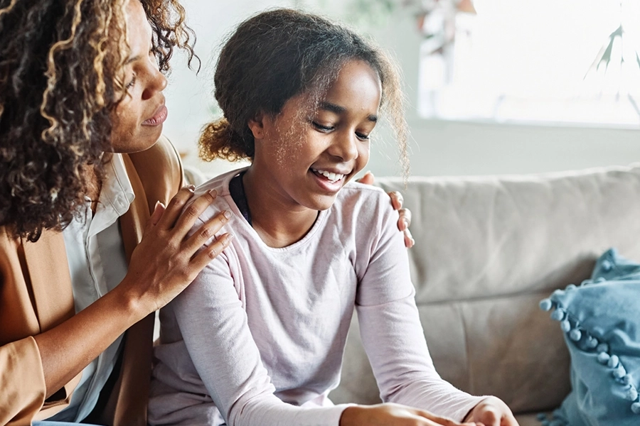 Young girl smiling with mom