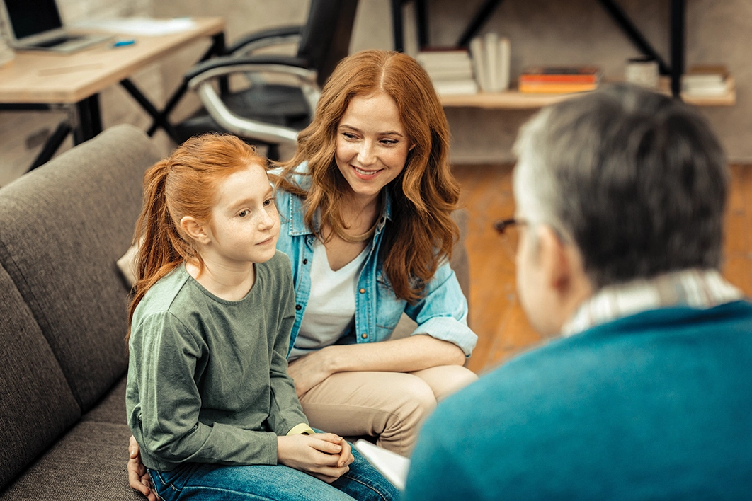 Red haired child in therapy session with mother