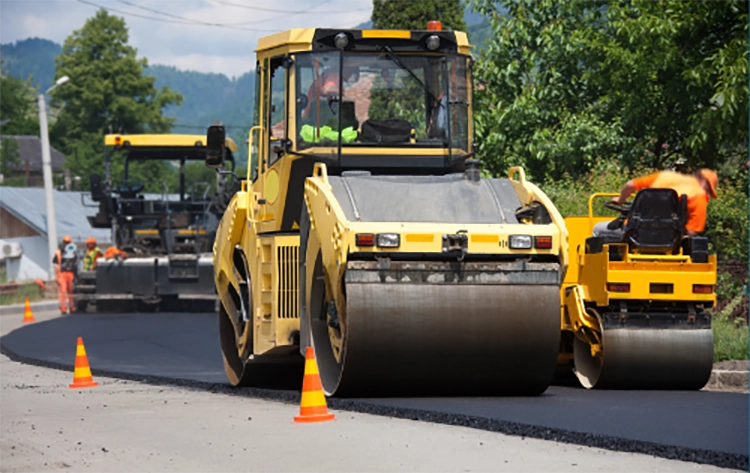 Road rollers paving a road