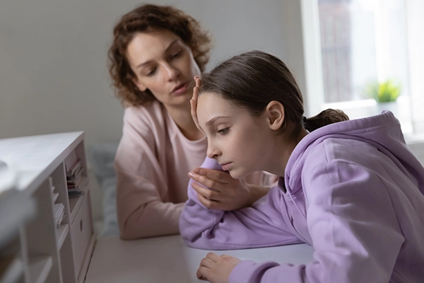 Affectionate mother giving psychological support to depressed young teen kid daughter. Stressed adolescent child girl feeling abused or suffering from bullying, parental help and devotion concept.