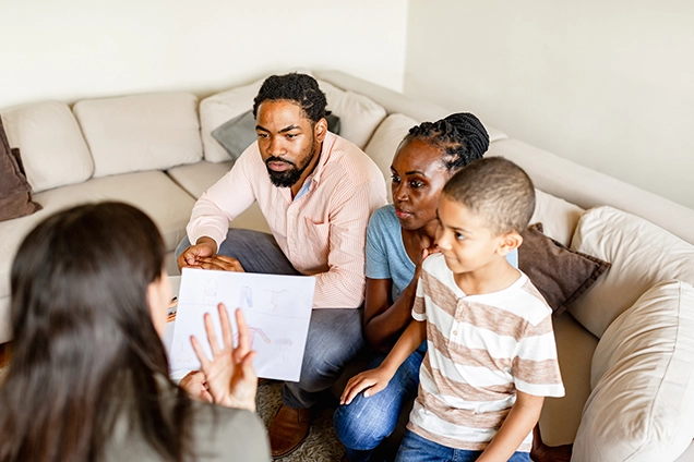 Parents and child meeting with an adult