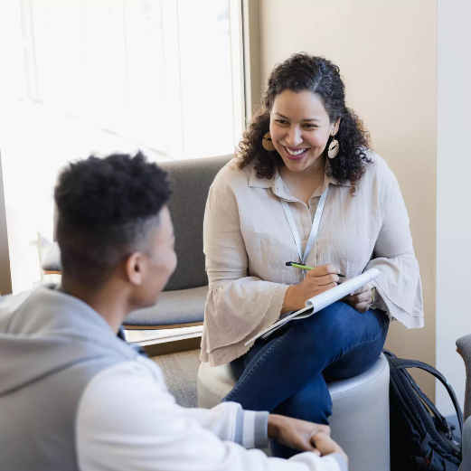 Female counselor talks with a teen